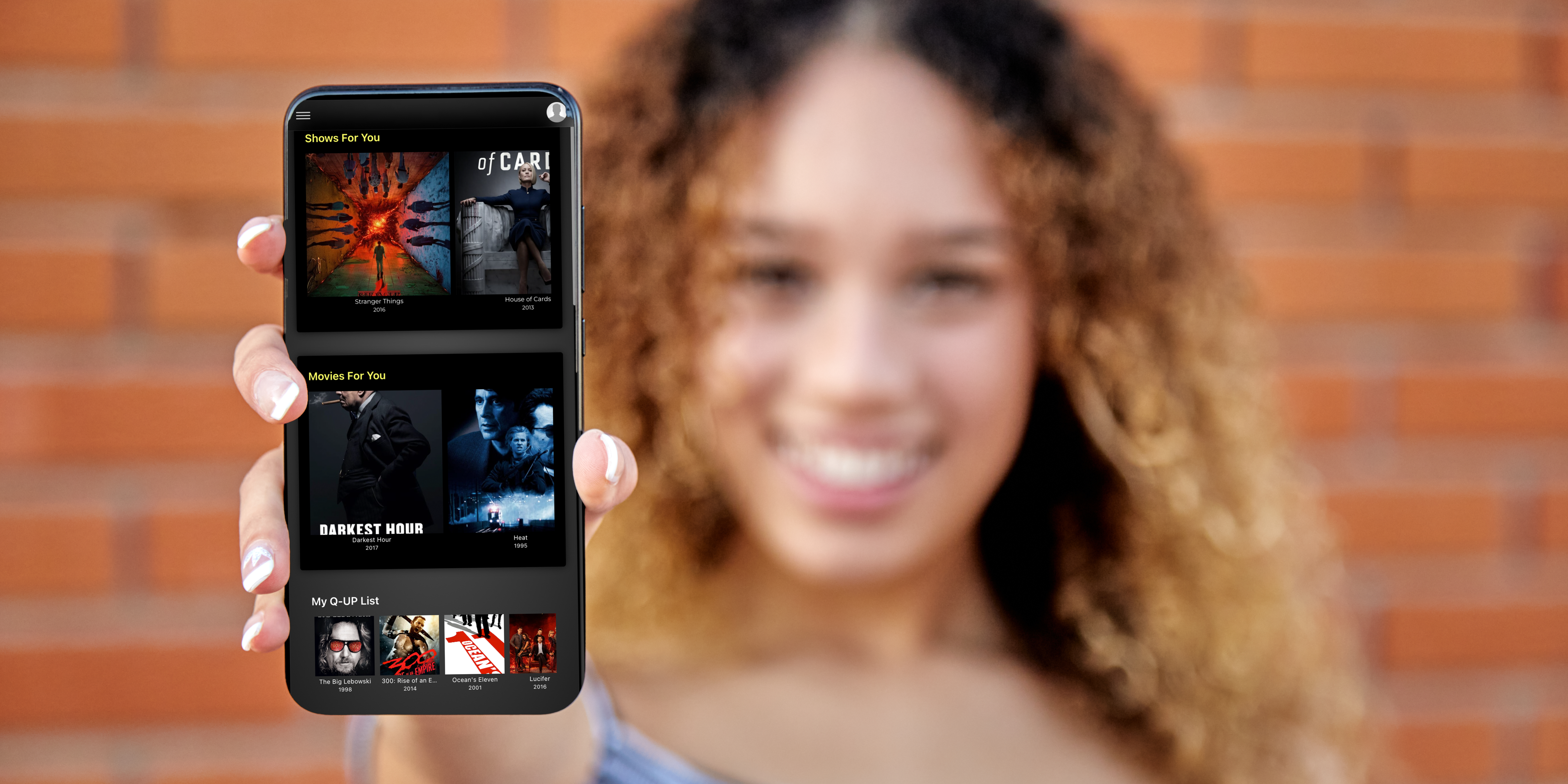 pretty-curly-haired-girl-showing-a-smart-phone-se-2023-11-27-05-02-57-utc girl with smartphone showing Q-UP